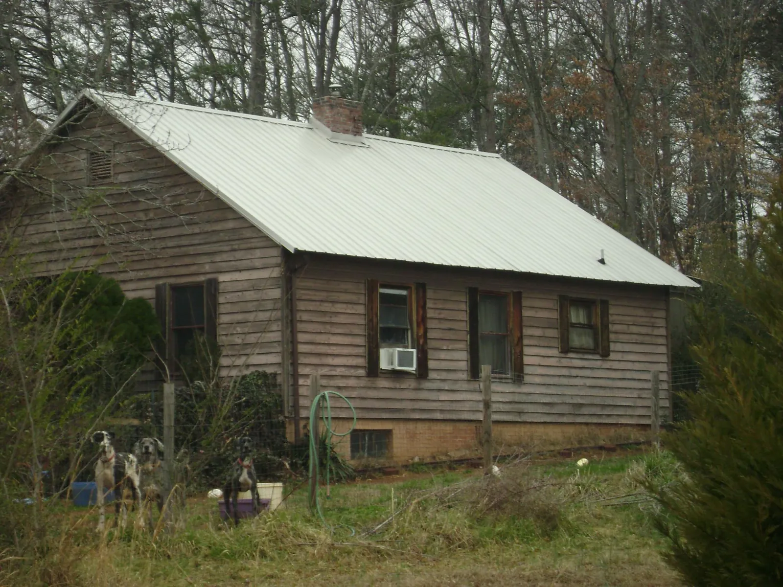 White metal roof on an old wood sided farmhouse, from a Metal Roof Installation job in Louisville